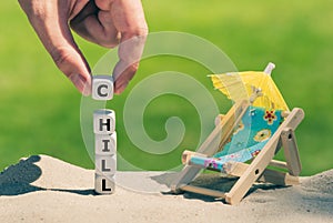 Dice placed next to a beach chair form the word `chill`