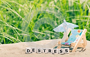 Dice placed next to a beach chair form the word `destress`