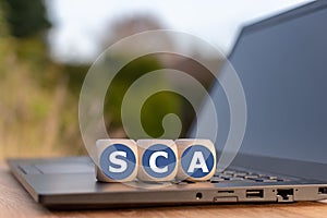 Dice placed on a notebook for with the abbreviation `SCA` photo