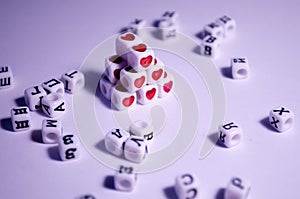 Dice pyramid with hearts. Cubes with hearts and letters. The 14th of February. Hearts on white cubes. Dice beads. Love