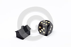 Dice and a small black plastic house
