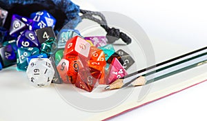 Dice spilling out of a Dice bag with Pencils