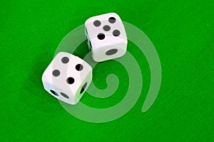 Dice white on green cloth or cloth
