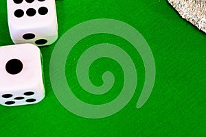 Dice white on green cloth or cloth