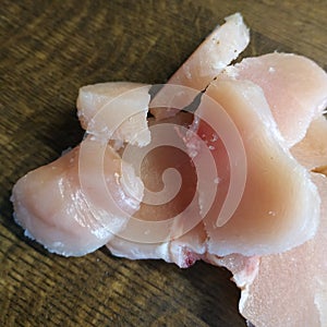 Diced chicken pieces of healthy lean white meat on a cutting board, filleted for cooking