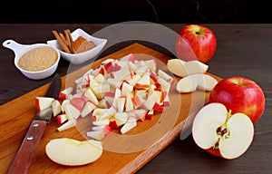 Diced fresh apples on wooden chopping board for making apple compote