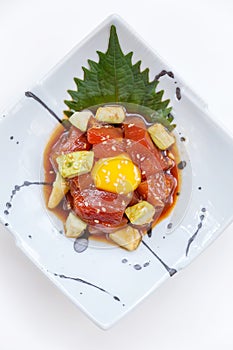 Diced Maguro Bluefin Tuna Salad with Diced Avocado and Egg Yolk Served on Japanese Ink Painted Ceramic Plate