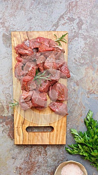 Diced raw meat with a sprig of rosemary