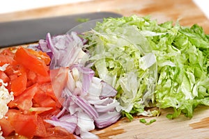 Diced vegetables and cheese on cutting board