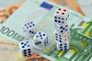 Dices on euro money background - Concept of risky investments and gamble