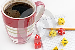 Dices for rpg, dnd or board games, notebook, pencil and a mug of coffee.