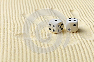 Dices on sand surface and palm print