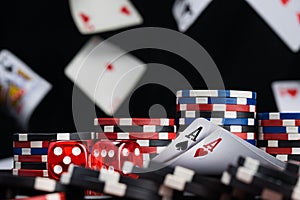 Dices and two ace cards surrounded by poker chips background of falling cards