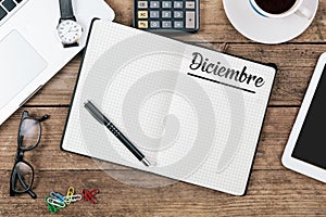 Diciembre Spanish December month name on paper note pad at off photo