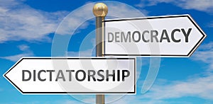 Dictatorship and democracy as different choices in life - pictured as words Dictatorship, democracy on road signs pointing at photo
