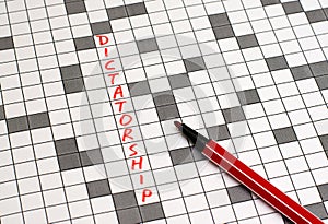 Dictatorship. Text in crossword. Red letters photo