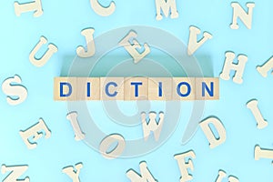 Diction speech class lesson. Wooden blocks typography word flat lay in blue background. photo