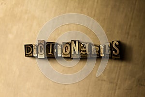 DICTIONARIES - close-up of grungy vintage typeset word on metal backdrop