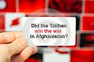 Did the Taliban win the war in Afghanistan - question on paper in a man`s hand on a red background photo
