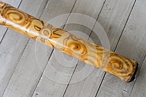 Didgeridoo music instrument closeup on grey boards background