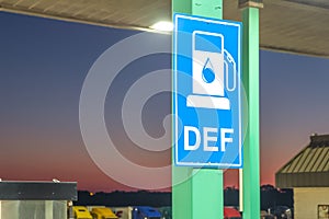 Diesel exhaust fluid or DEF sign posted in a truck stop, next to fuel pump photo