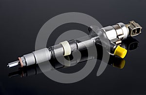 Diesel fuel injector isolated on black photo