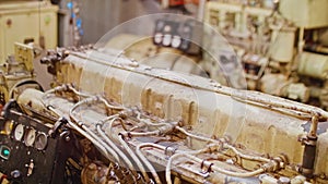 Diesel generator and black dashboard in engine room of old tug.