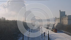 Diesel locomotive with fuel moves along the railway tracks. Smoke from the chimney.