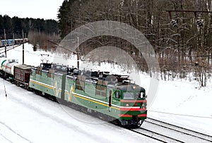 Diesel locomotive with wagons locomotive rides by rail in winter