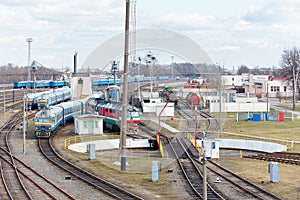 Diesel locomotives and carriages stand in depot near railway turntable