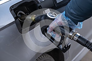 Diesel. Refueling the car.Refueling pistol in the hands of a man in a glove.A man fills up a car tank