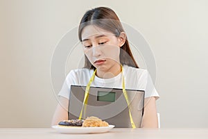 Diet, attractive asian young woman, girl restrained to eat doughnut, bakery and fried chicken, fast food to lose, loss weight,