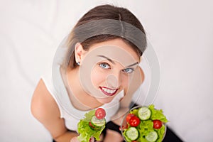 Diet. Beautiful Young Woman Eating Vegetable Salad