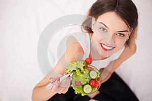 Diet. Beautiful Young Woman Eating Vegetable Salad