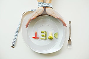 Diet. Close up of plate with vegetable diet letters