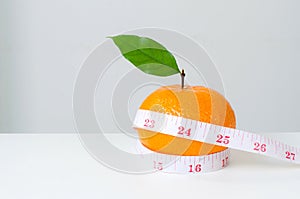 Diet concep, Orange fruit and measuring tape