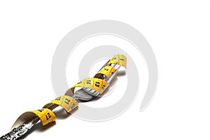 Diet concept. Bright yellow measuring tape and fork isolated on a white background