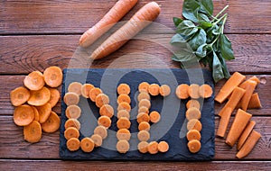 Diet concept. Different cut of carrots on wooden background