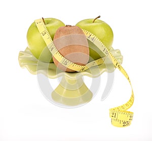 Diet concept, kiwi fruit with green apple and measuring tape