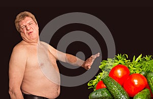 The diet concept - overweight and fat man denying healthy food photo