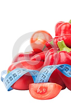 Diet concept: Set from red bell pepper, red hot chili pepper and apple with measuring tape