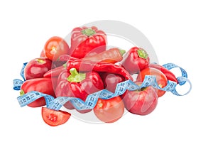 Diet concept: Set from red bell pepper, red hot chili pepper and apple with measuring tape