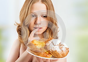 Diet concept. woman on a diet dreaming of buns