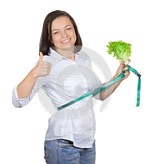 Diet Concept. Young Woman with Lettuce Measuring Her Waistline w