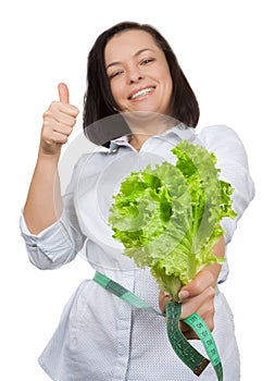 Diet Concept. Young Woman with Lettuce Measuring Her Waistline w