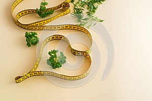 Diet concept on yulow background with measuring tape . Eco-friendly, vegan food