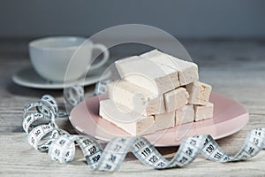 Diet dessert with measure tape and cup of tea