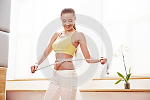 Diet. Dieting concept. Woman in Sportswear Measuring Her Waist