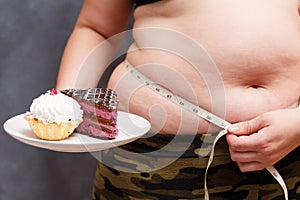Diet, dieting, junk food concept. Close up of young obese overwe