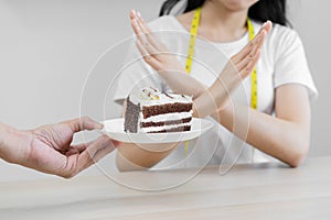 Diet, Dieting unhealthy asian young woman hand in deny, rejecting eat chocolate cake or sweet taste, fighting to keep it from